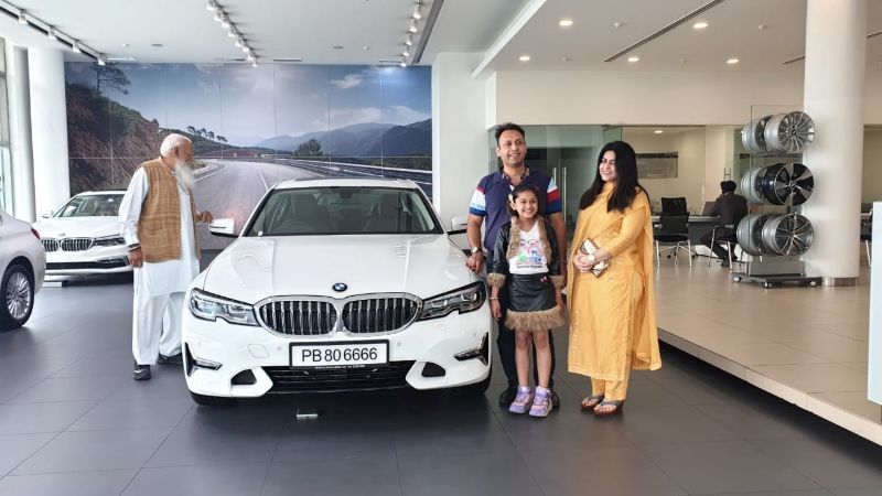 Rahul Kaushl posing for a photo with his BMW